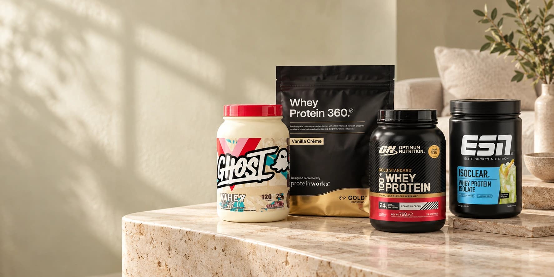 Ghost, Protein Works, Optimum Nutrition and ESN products in a sunlit stone-table scene.